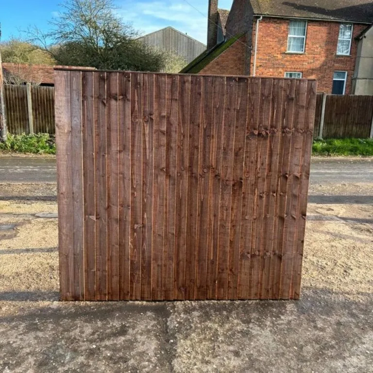Decorative omega lattice fence panels with curved tops and trellis designs installed in a landscaped garden.